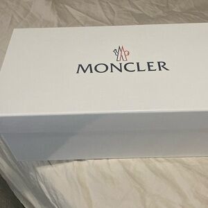 Moncler Slides with blue and red stripe gently worn like new.